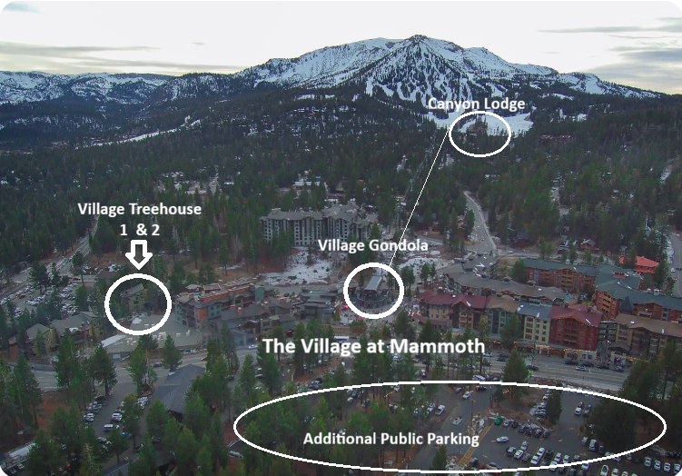 Aerial view of The Village at Mammoth showing Village Treehouse 1 & 2, the Village Gondola, Canyon Lodge and additional public parking